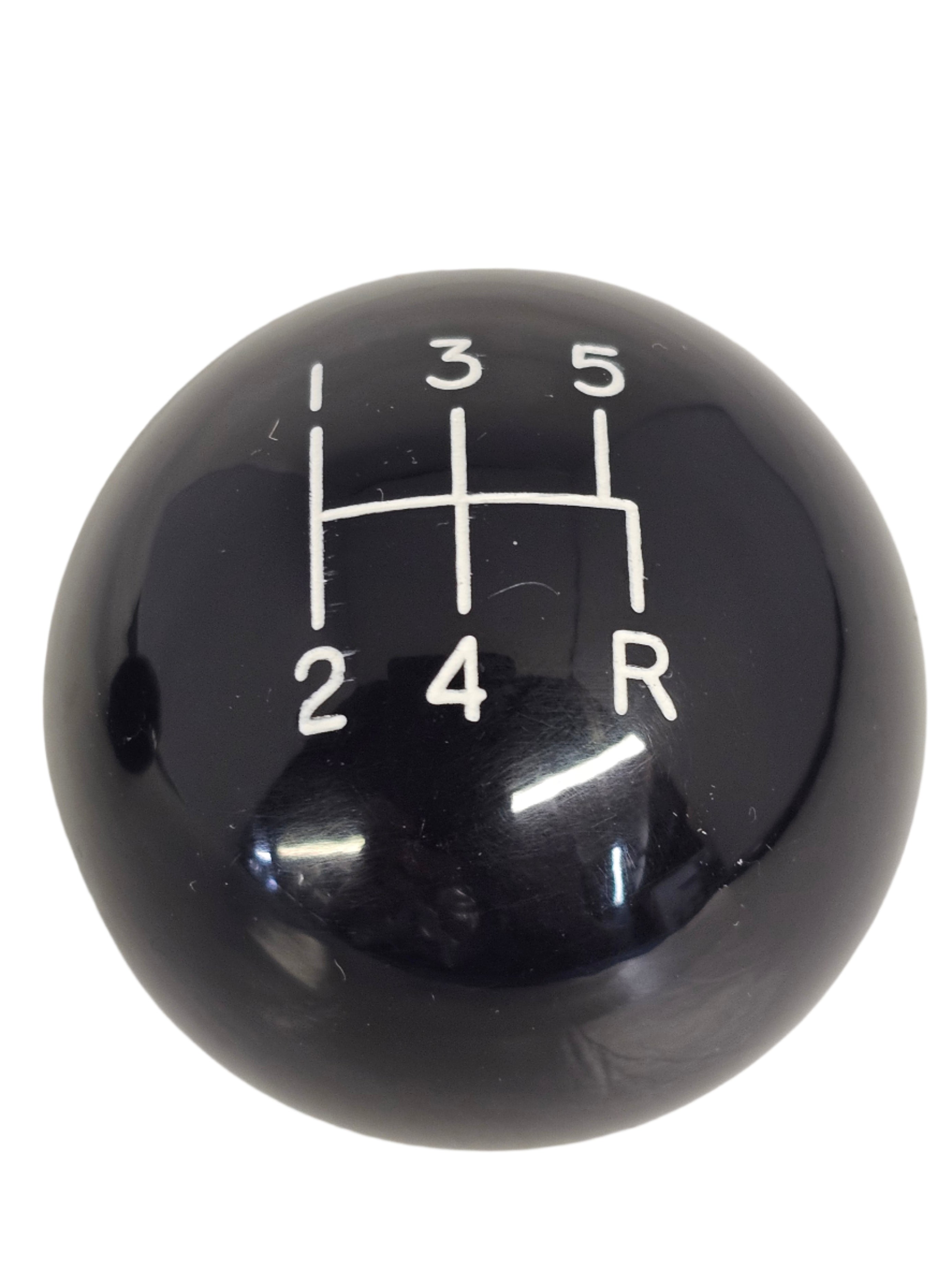 Black gear shift knob with white numbering on a white background