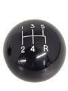 Black gear shift knob with white numbering on a white background