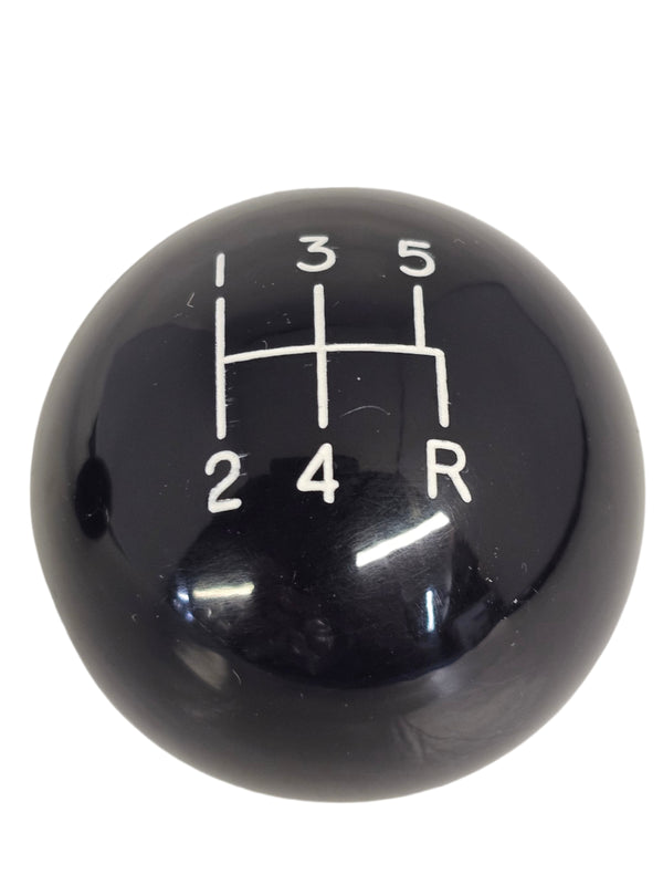 Black gear shift knob with white numbering on a white background